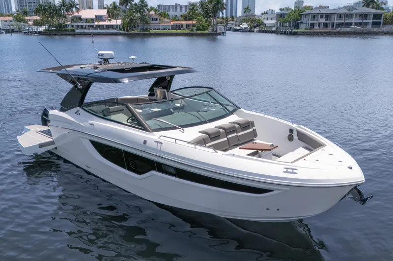  Yacht Photos Pics 2021 Cruisers Yachts 38 GLS boat on calm water, featuring sleek design and spacious seating.