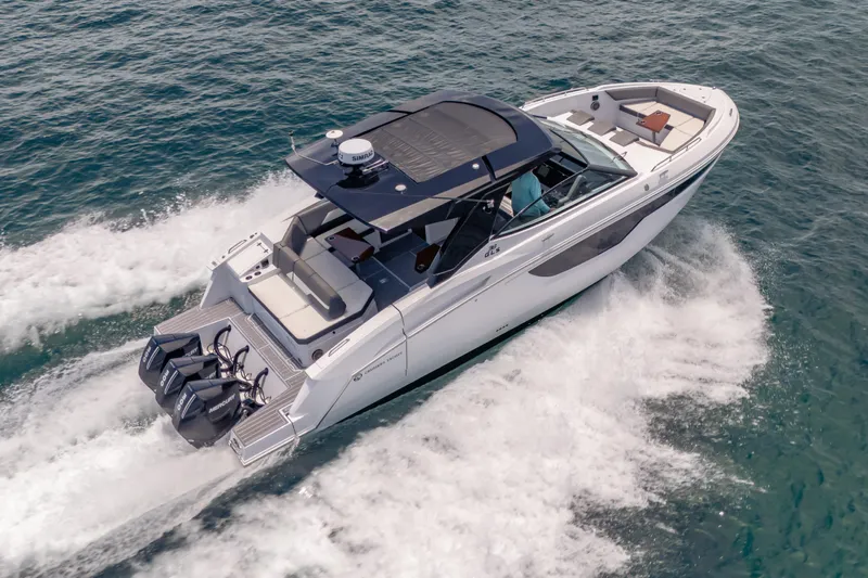  Yacht Photos Pics 2021 Cruisers Yachts 38 GLS speeding on open water, showcasing sleek design and powerful engines.