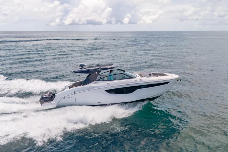  Yacht Photos Pics 2021 Cruisers Yachts 38 GLS speeding on open water under a cloudy sky.