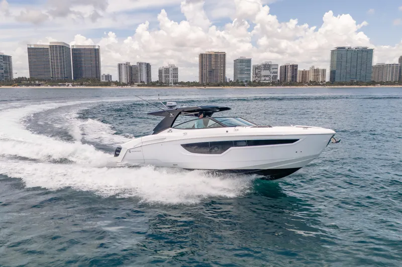  Yacht Photos Pics 2021 Cruisers Yachts 38 GLS cruising near city skyline on a sunny day.