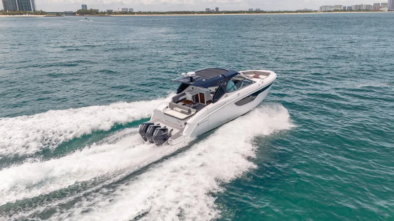  Yacht Photos Pics 2021 Cruisers Yachts 38 GLS speeding on open water, showcasing sleek design and powerful engines.