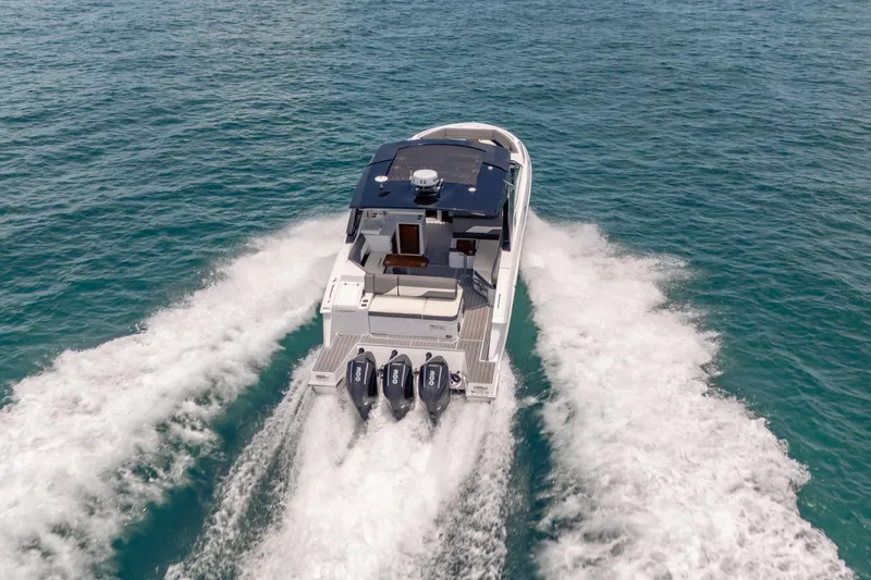  Yacht Photos Pics 2021 Cruisers Yachts 38 GLS speeding on open water, showcasing powerful triple engines.