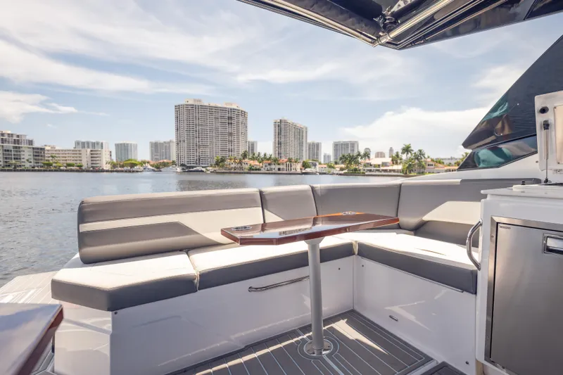  Yacht Photos Pics Luxurious 2021 Cruisers Yachts 38 GLS interior with waterfront cityscape view.