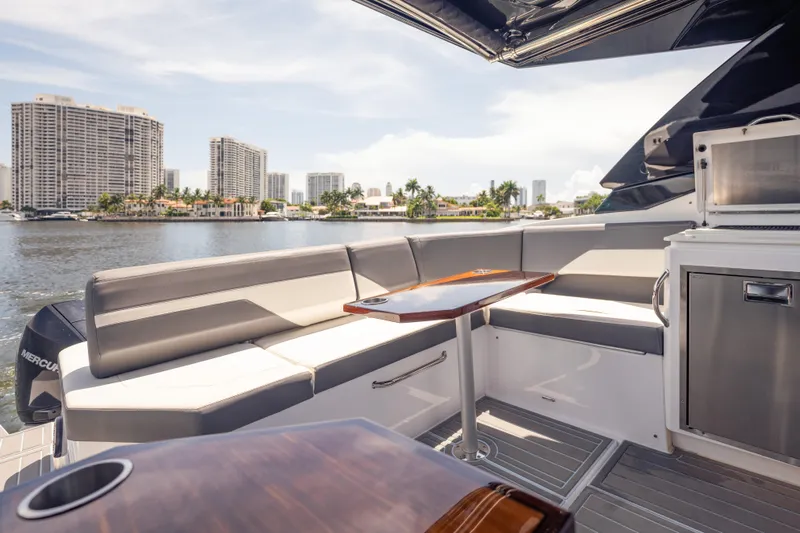  Yacht Photos Pics Luxurious 2021 Cruisers Yachts 38 GLS interior with waterfront cityscape view.