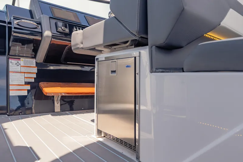  Yacht Photos Pics 2021 Cruisers Yachts 38 GLS interior with seating and stainless steel mini-fridge.