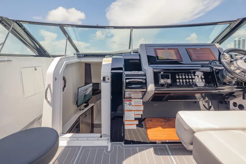  Yacht Photos Pics 2021 Cruisers Yachts 38 GLS helm with modern controls and cabin view.