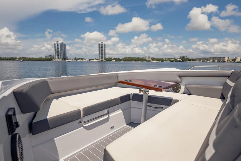  Yacht Photos Pics Luxurious seating area on 2021 Cruisers Yachts 38 GLS, overlooking serene waterfront skyline.