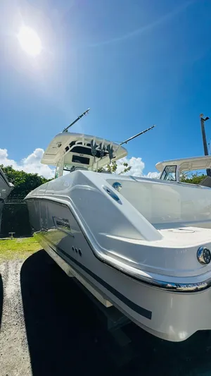  Yacht Photos Pics 2023 Boston Whaler 330 Outrage boat under clear blue sky.