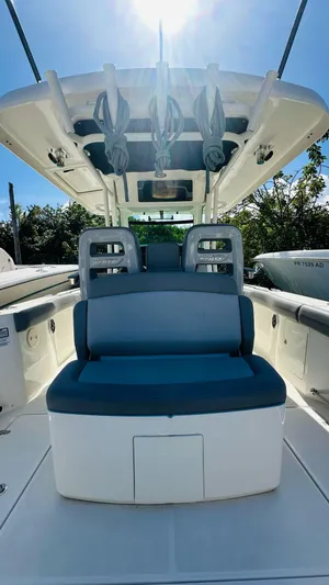  Yacht Photos Pics 2023 Boston Whaler 330 Outrage boat interior with seating and overhead storage.