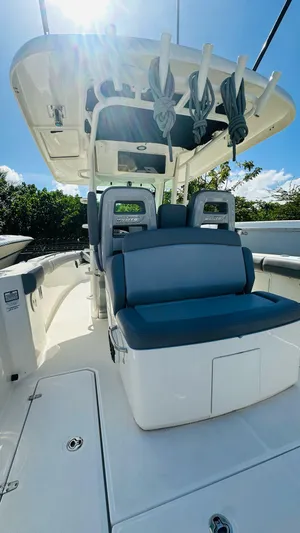  Yacht Photos Pics 2023 Boston Whaler 330 Outrage boat interior with seating and overhead storage.