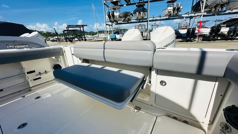  Yacht Photos Pics 2023 Boston Whaler 330 Outrage boat interior with seating and storage.
