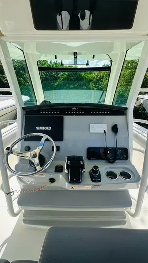  Yacht Photos Pics 2023 Boston Whaler 330 Outrage helm with Simrad electronics and modern controls.