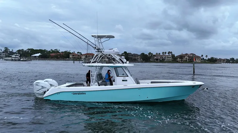 Engine Warranty Yacht Photos Pics 2023 Everglades 365 CC boat on water with fishing rods and twin engines.