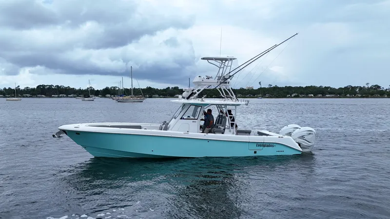 Engine Warranty Yacht Photos Pics 2023 Everglades 365 CC boat on water, cloudy sky, coastal background.