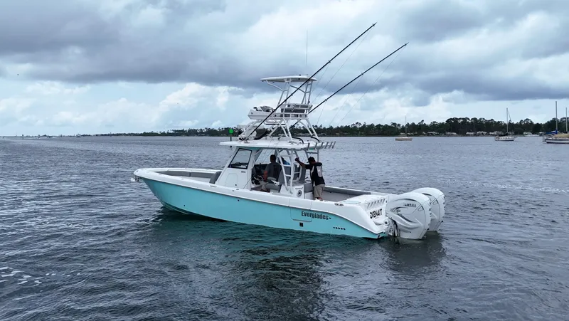 Engine Warranty Yacht Photos Pics 2023 Everglades 365 CC boat on water, cloudy sky, fishing rods visible.