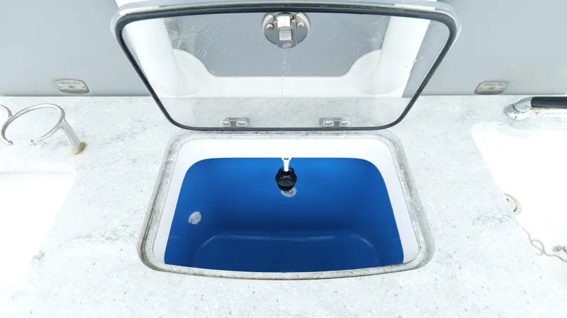 Engine Warranty Yacht Photos Pics Open livewell on 2023 Everglades 365 CC boat, featuring a blue interior.