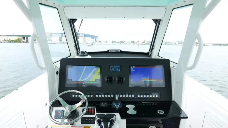 Engine Warranty Yacht Photos Pics 2023 Everglades 365 CC boat dashboard with navigation screens and steering wheel.