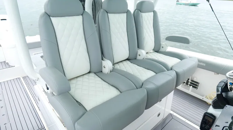 Engine Warranty Yacht Photos Pics Luxury seating on 2023 Everglades 365 CC boat, featuring gray and white quilted upholstery.
