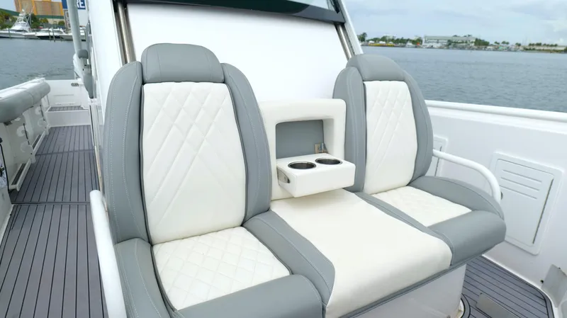 Engine Warranty Yacht Photos Pics Luxury seating on 2023 Everglades 365 CC boat with cup holders, dockside view.