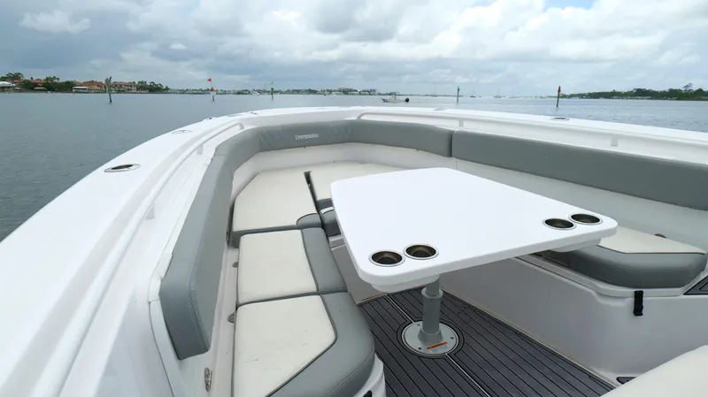 Engine Warranty Yacht Photos Pics 2023 Everglades 365 CC boat interior with seating and table on a calm waterway.