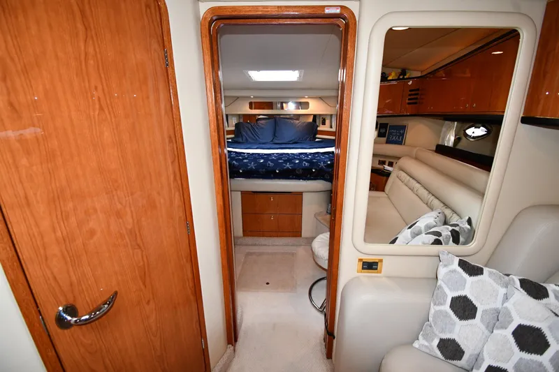  Yacht Photos Pics Luxurious interior of 2000 Sea Ray 460 Sundancer yacht with cozy bedroom and seating area.