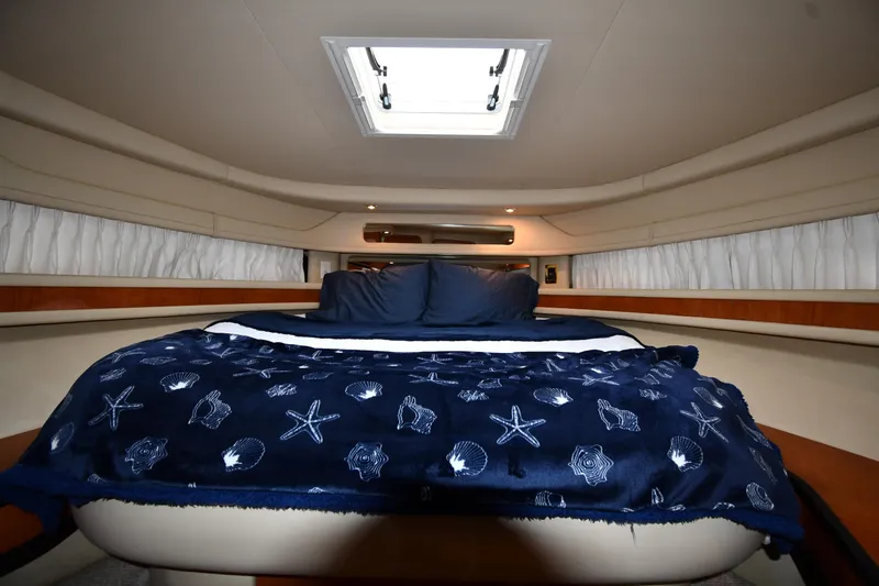  Yacht Photos Pics Luxurious cabin interior of 2000 Sea Ray 460 Sundancer yacht with nautical-themed bedding.