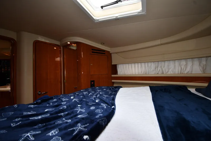  Yacht Photos Pics Luxurious cabin interior of 2000 Sea Ray 460 Sundancer yacht with skylight and nautical bedding.
