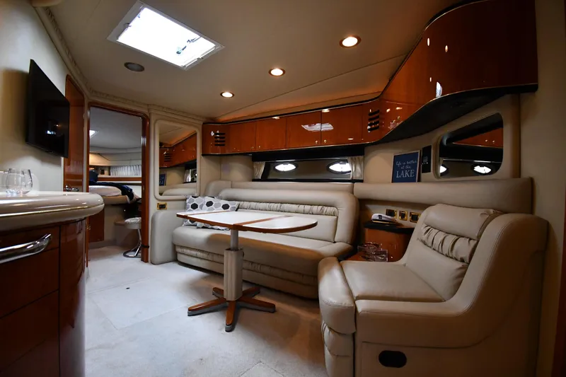  Yacht Photos Pics Luxurious interior of a 2000 Sea Ray 460 Sundancer yacht with plush seating and elegant wood finishes.