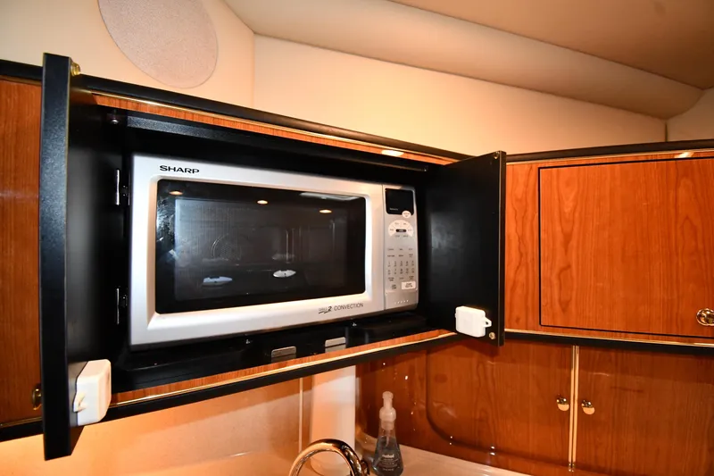  Yacht Photos Pics Microwave in 2000 Sea Ray 460 Sundancer yacht kitchen, wooden cabinetry.