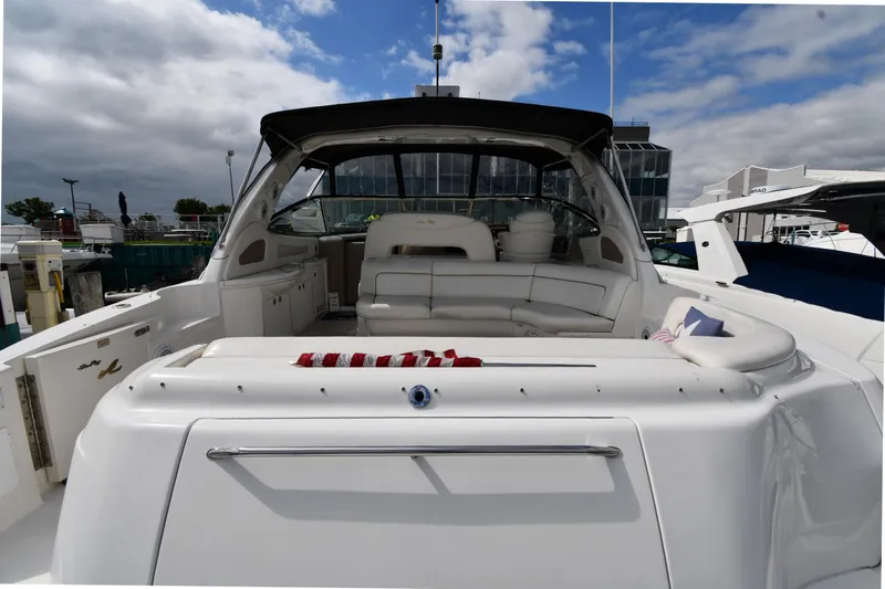  Yacht Photos Pics 2000 Sea Ray 460 Sundancer yacht with spacious seating, docked under cloudy skies.