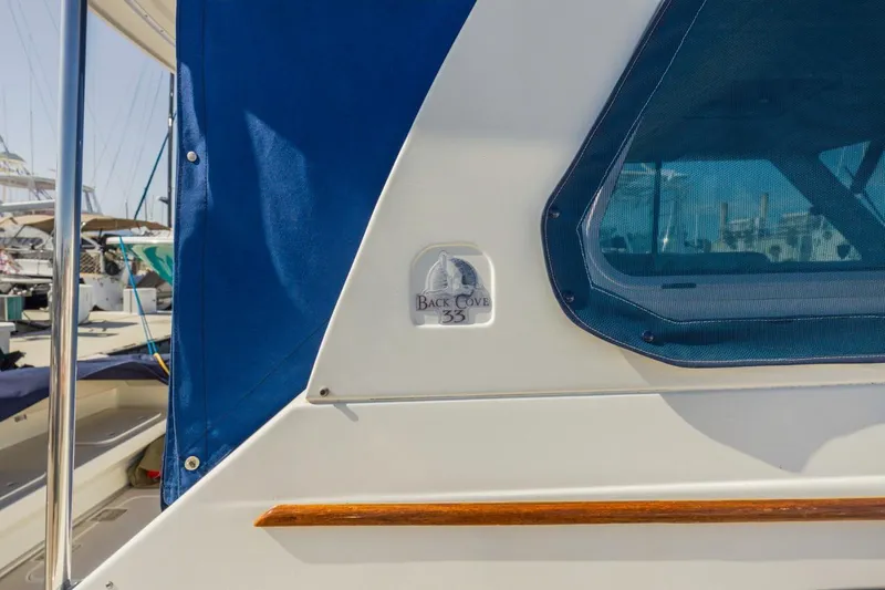 Kaholo Yacht Photos Pics 2008 Back Cove 33 boat with blue canopy and window detail.