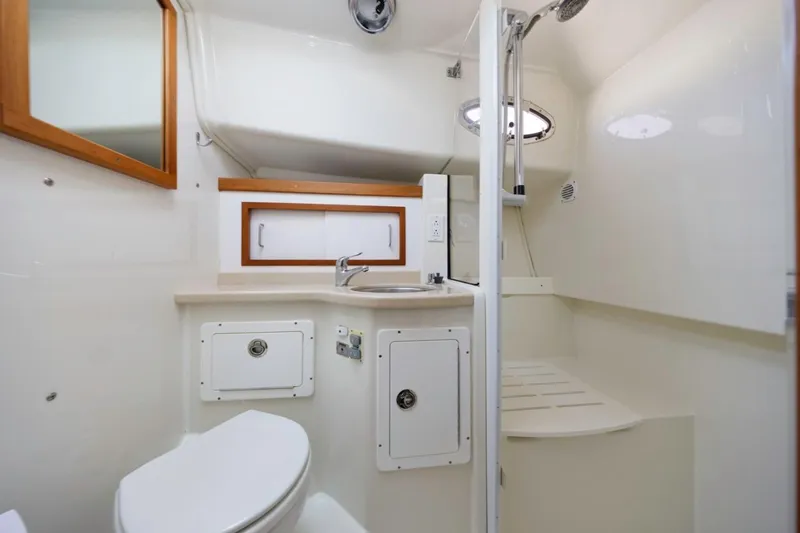 Kaholo Yacht Photos Pics 2008 Back Cove 33 yacht bathroom with shower, sink, and toilet in compact, modern design.