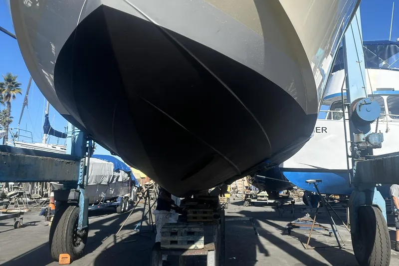 Kaholo Yacht Photos Pics 2008 Back Cove 33 boat in dry dock, hull view, surrounded by other vessels.