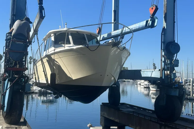 Kaholo Yacht Photos Pics 2008 Back Cove 33 boat being lifted at a marina with clear blue skies.