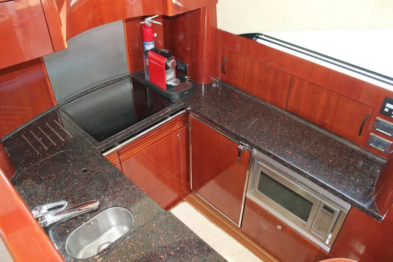 M/y Oneiro Yacht Photos Pics Luxurious 2008 Fairline 58 yacht kitchen with sleek countertops and modern appliances.