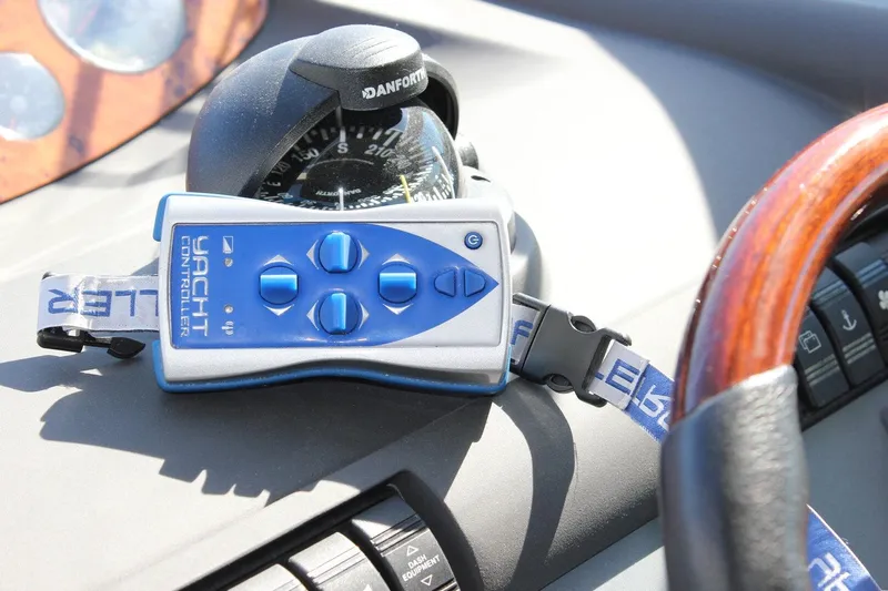 M/y Oneiro Yacht Photos Pics Remote yacht controller on Fairline 58 dashboard, 2008 model, with compass and steering wheel.