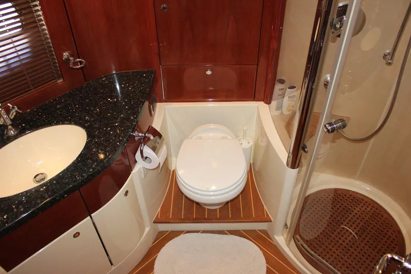 M/y Oneiro Yacht Photos Pics Luxurious 2008 Fairline 58 yacht bathroom with modern fixtures and elegant wood accents.
