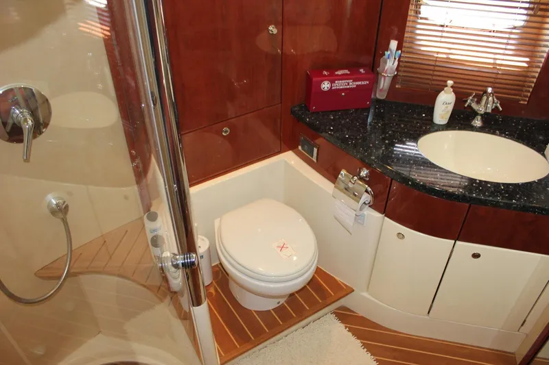 M/y Oneiro Yacht Photos Pics Luxurious 2008 Fairline 58 yacht bathroom with modern fixtures and elegant wood accents.