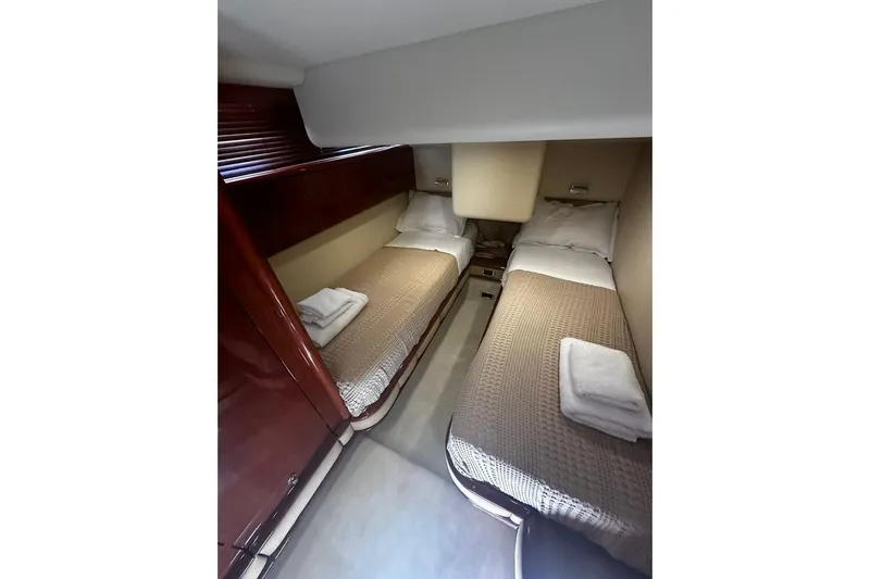 M/y Oneiro Yacht Photos Pics Twin beds in a 2008 Fairline 58 yacht cabin with cozy bedding.
