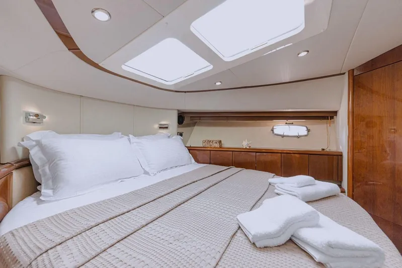 M/y Oneiro Yacht Photos Pics Luxurious cabin interior of 2008 Fairline 58 yacht with skylights and elegant bedding.