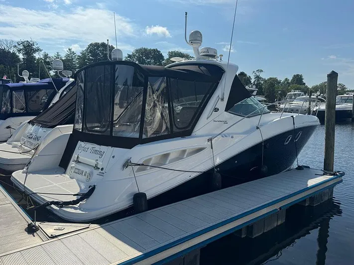  Yacht Photos Pics 2009 Sea Ray 330 Sundancer docked at marina, featuring sleek design and covered cockpit.