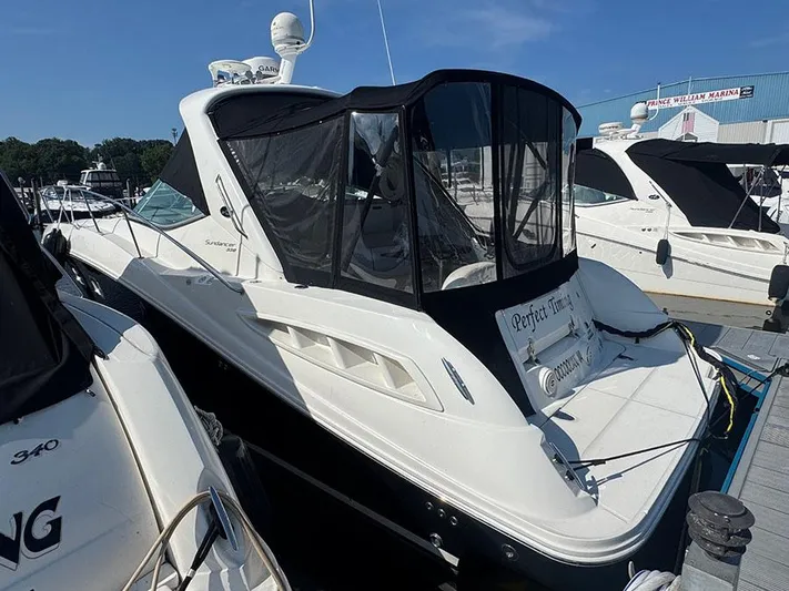  Yacht Photos Pics 2009 Sea Ray 330 Sundancer docked at marina, featuring sleek design and black canopy.