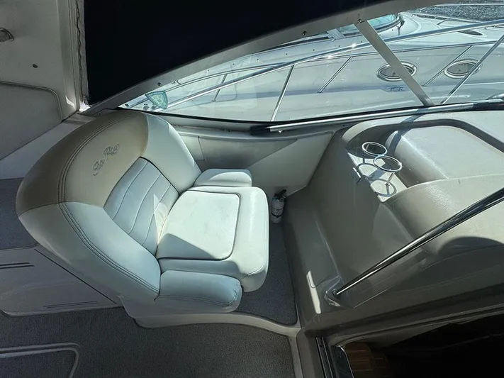  Yacht Photos Pics Captain's seat in 2009 Sea Ray 330 Sundancer boat cockpit, featuring cup holders.