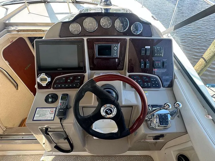  Yacht Photos Pics 2009 Sea Ray 330 Sundancer helm with steering wheel, gauges, and navigation controls.