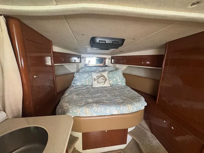  Yacht Photos Pics 2009 Sea Ray 330 Sundancer cabin interior with bed and wood cabinetry.