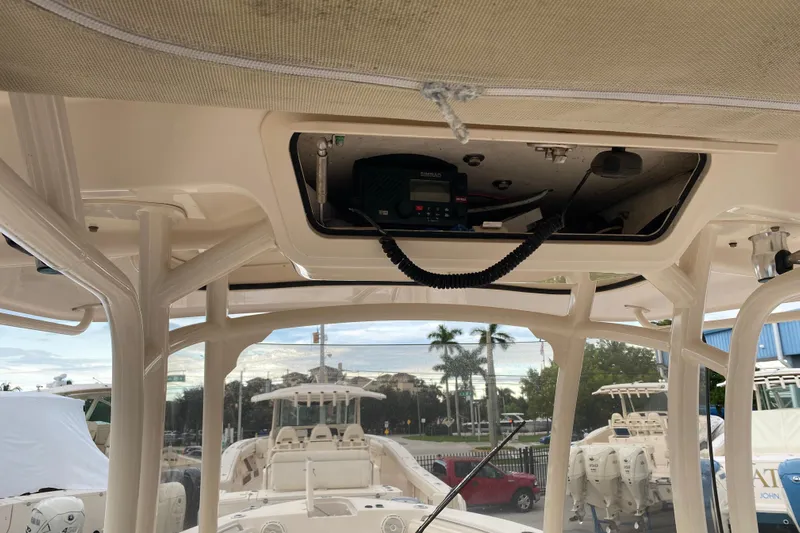  Yacht Photos Pics 2018 Grady-White Canyon 306 boat interior with electronic equipment and overhead storage.