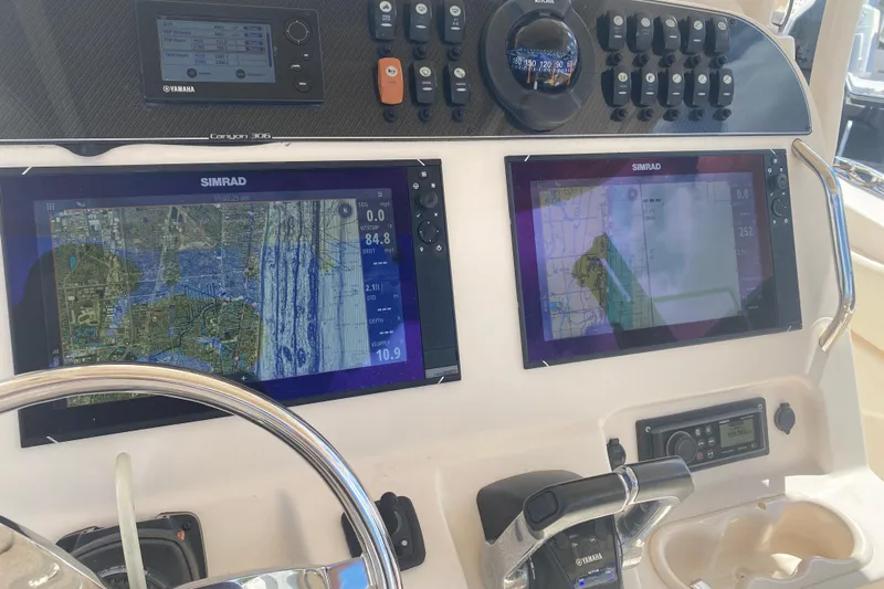  Yacht Photos Pics 2018 Grady-White Canyon 306 dashboard with Simrad navigation displays and Yamaha controls.
