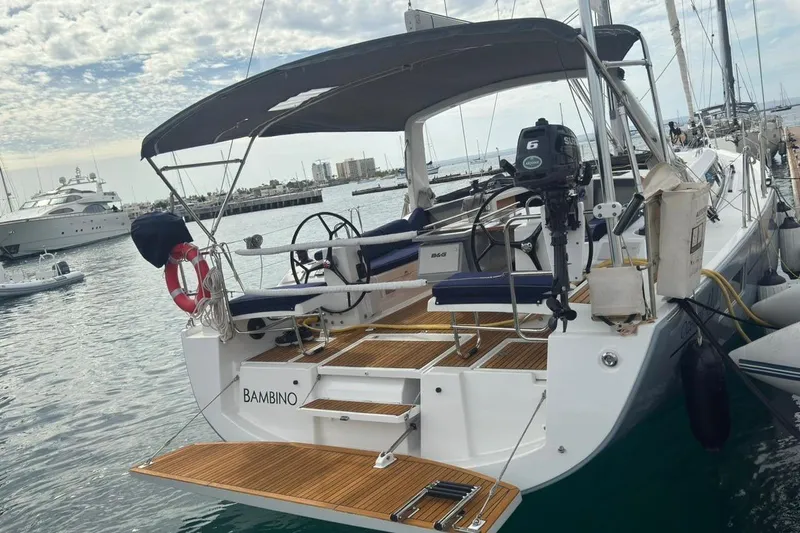 Bambino Yacht Photos Pics 2019 Beneteau Oceanis 41.1 sailboat docked in marina, featuring spacious deck and canopy.
