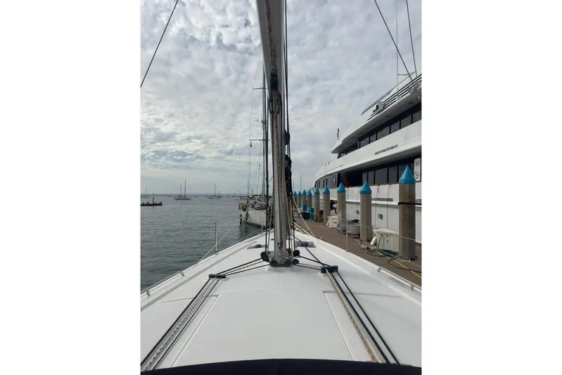 Bambino Yacht Photos Pics 2019 Beneteau Oceanis 41.1 sailboat docked at marina, cloudy sky background.