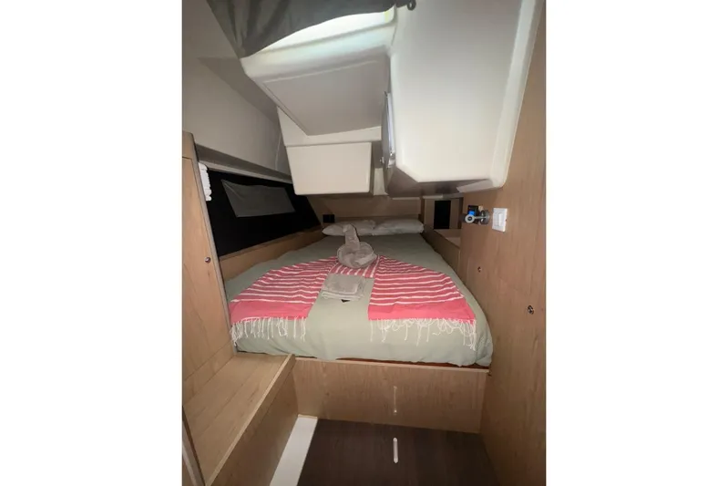 Bambino Yacht Photos Pics Cozy cabin interior of 2019 Beneteau Oceanis 41.1 with neatly arranged bed linens.